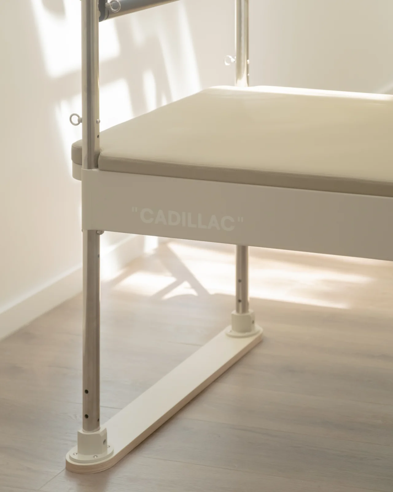 The stamped frame and padded bed of a cream fonv cadillac in soft daylight.